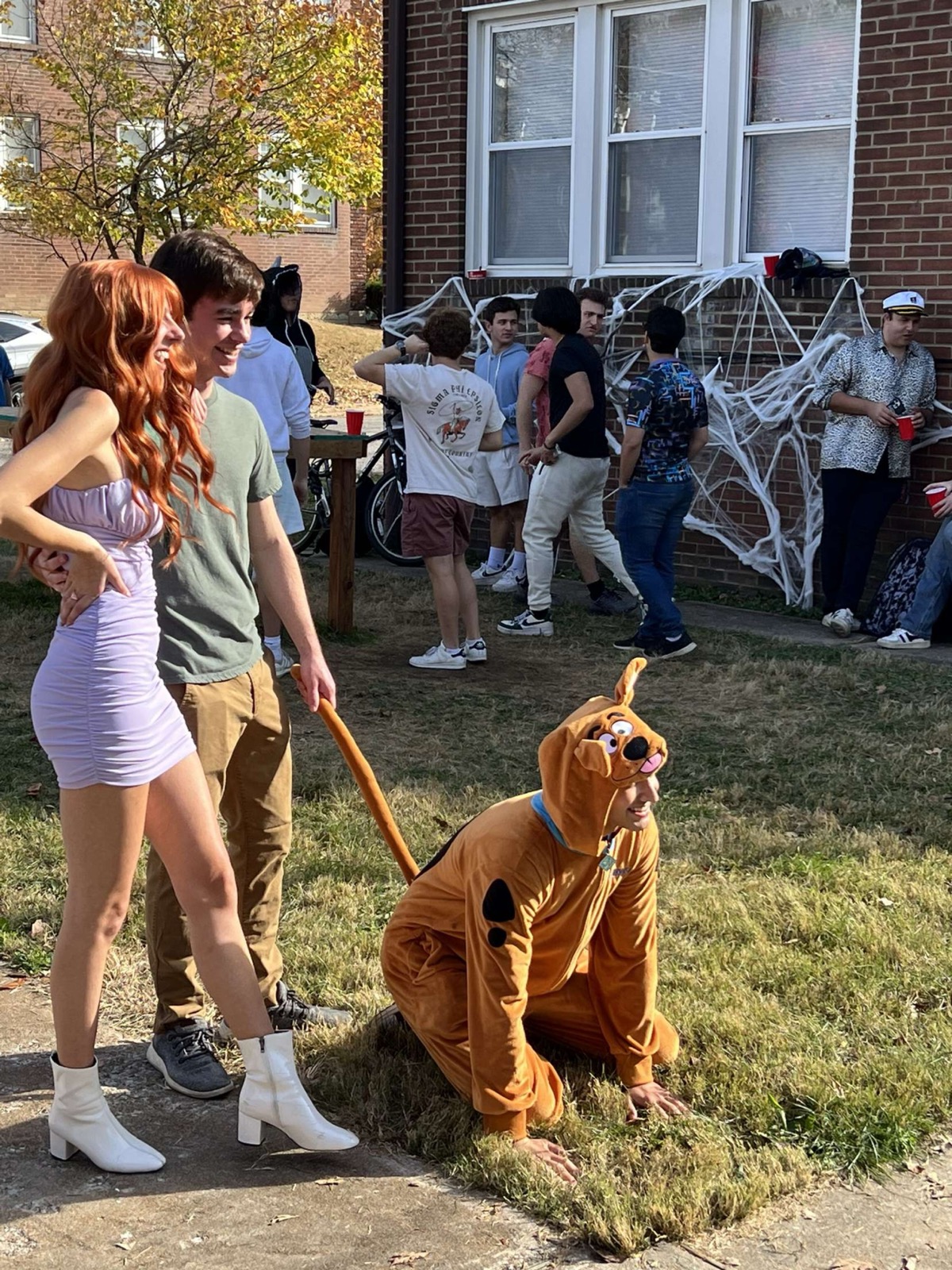 Ian Greenberg in a Scooby-Doo costume, on a leash, at a party
